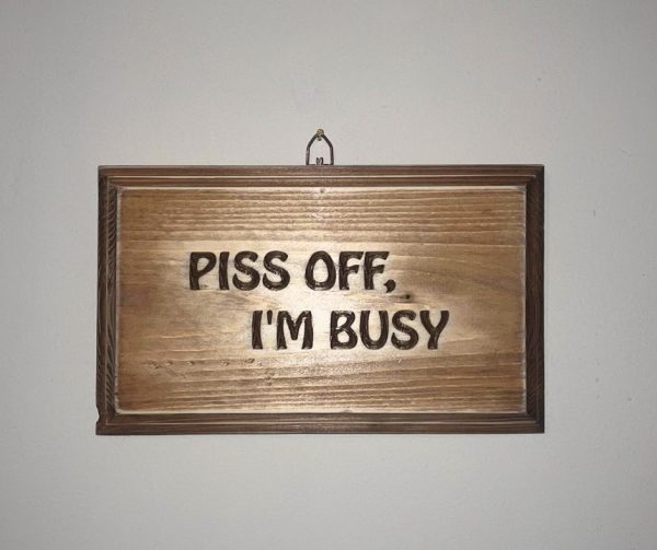Piss off i'm busy plaque